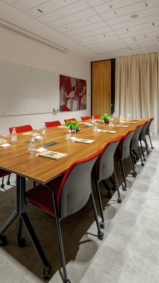 Series of Red and Black Chairs with Casters and a Table