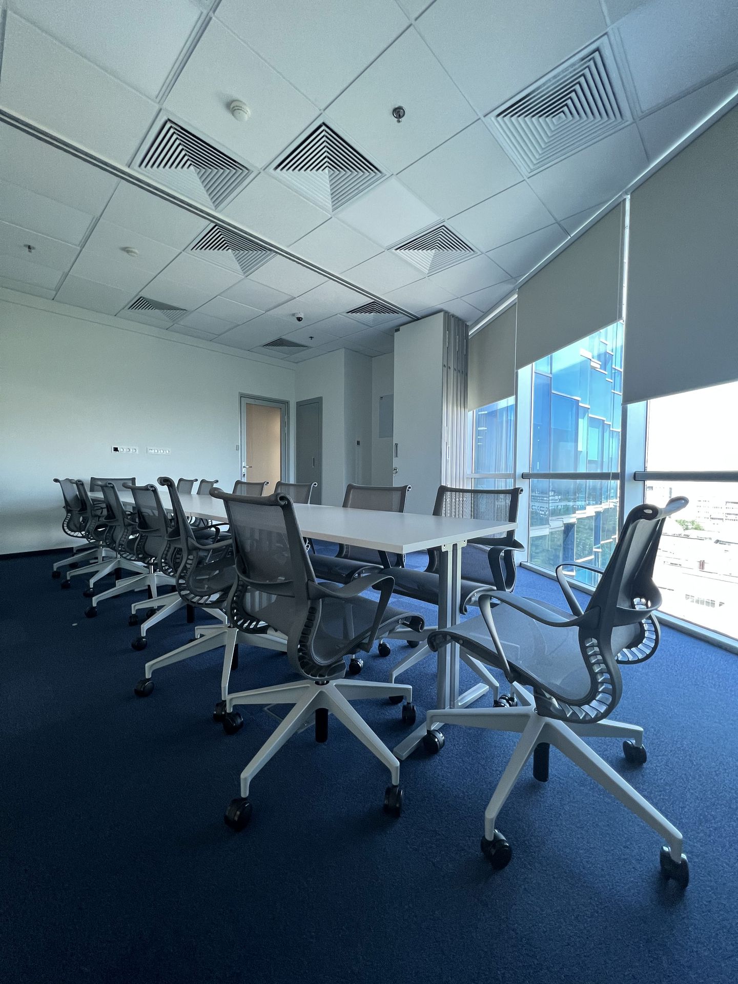 Herman Miller Ratio sit-stand desks — knowledge worker floor, international finance office Almaty
