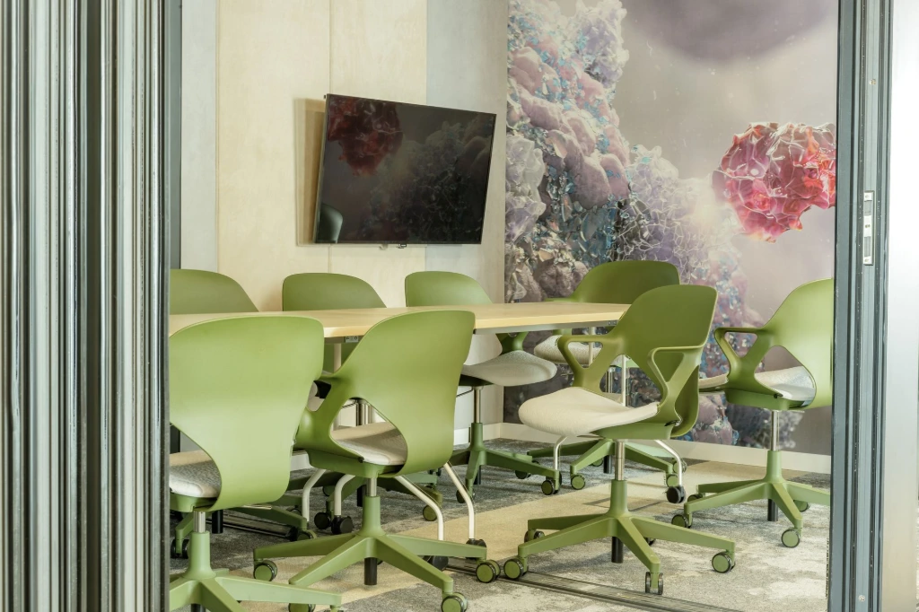 MillerKnoll Green-colored Zeph Chairs in a conference room