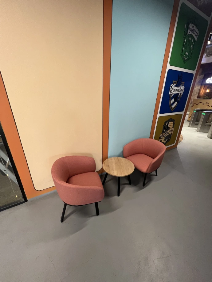 Pink Colored MillerKnoll Sofa Chairs with Wooden Table